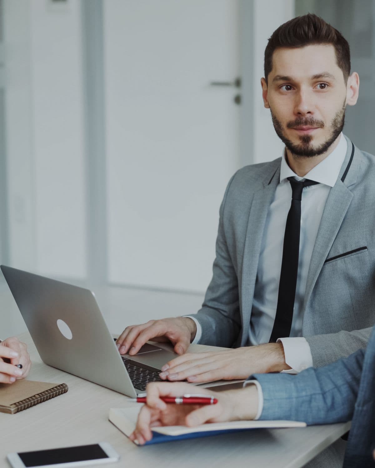 A marketing professional reviewing local search performance on a laptop in a bright, modern office.